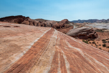 A rocky cliff with a red and brown color pattern
