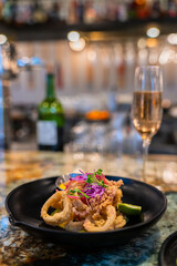 Bar and Grill Delight: Fried Calamari with Red Cabbage, Orange Sauce, Pickled Red Onion, Champagne, and Wine