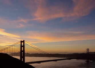 Fototapeta premium Golden Gate Bridge Sunrise View San Fransisco, California, Blue Sky Pink Clouds Beautiful Morning Landscape View of Bay Area Harbor Cityscape