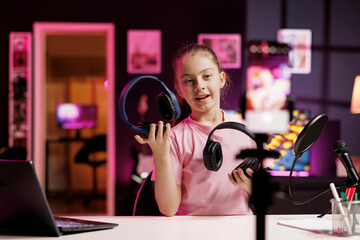 Generation Z technology content creator filming headphones review, comparing bass power...