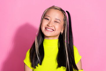 Photo of adorable pretty good mood asian girl with dyed hairstyle dressed yellow t-shirt winking...