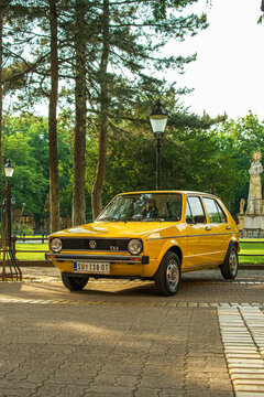 Yellow Volkswagen Golf 1 J GL (3 door, J - Jugoslavia, TAS plant, Sarajevo) in excellent condition is parked in Subotica, Serbia, 21.06.2023 Vertical image