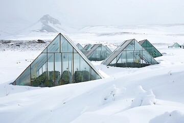 A series of geometrically shaped greenhouses in a snowy tundra