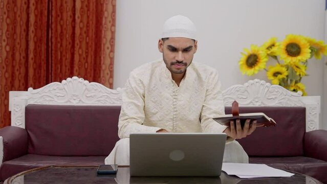 Seriouse Muslim Man Sitting on Sofa and Doing Debt Paperwork