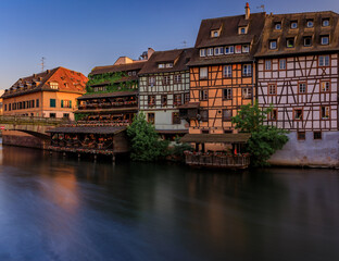 Half timbered houses by canals of Petite France in Strasbourg, France at sunset