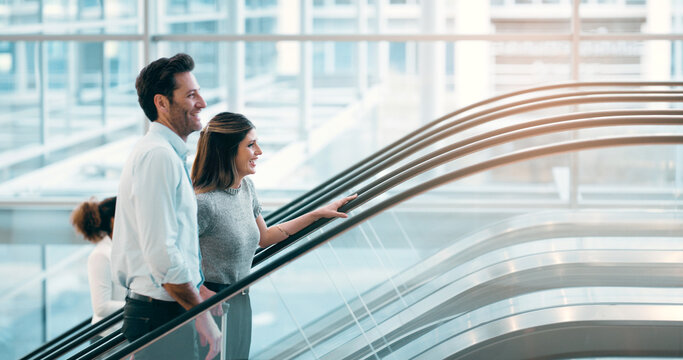 Escalator, morning and business people in office talking for arrival in lobby for work, job or career. Modern building, corporate team and workers on electrical stairs chat, workplace and coworker