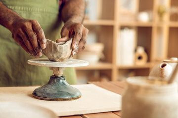 Close up of sculptors hands working with clay