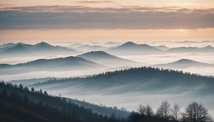 Obraz premium mountain layers and sunrise view in cold and foggy weather.