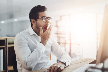 Tired, yawn and business man in office on computer for deadline on web design, project and research. Corporate, burnout and exhausted, fatigue and overworked worker in morning on pc for website ui