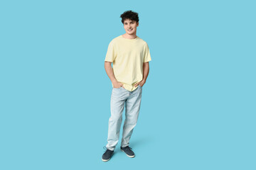 Fototapeta premium Handsome young man in stylish clothes on blue background