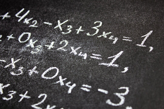 Algebra equation on chalk board. Math concept, teaching algebra written equation.