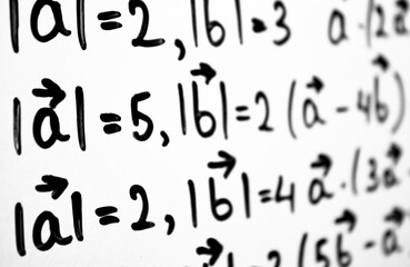An algebraic equation written in marker on a white board. Math concepts, calculating equations.