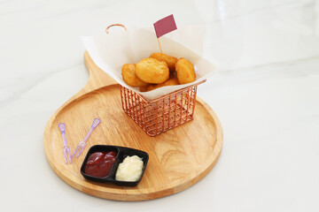 Fried chicken nuggets at restaurant with sauce