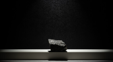composition of stones for the podium. natural black stones on a dark background for the podium...