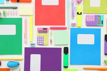 Different notebooks and stationery on white background