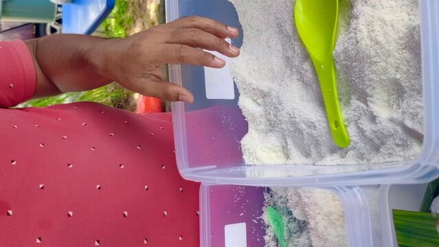 Bangi, Malaysia, July 16, 2023. The process of making Putu Perak, a traditional snack, at a local stall. 4K Vertical slow-motion