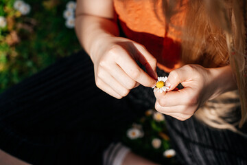 A close-up of hands crafting with flowers, capturing the essence of mindfulness and connection with...