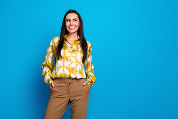 Photo of cheerful elegant lovely woman wear trendy clothes look offer empty space isolated on blue color background