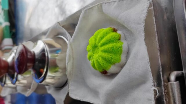 Freshly made Putu Perak pandan on the stove, a traditional snack in Malaysia. 4K Vertical