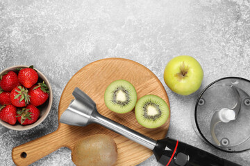 Hand blender kit and fresh fruits on grey table, flat lay