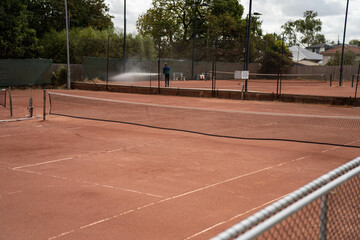 playing a clay court tennis match. people hipsters watching having social sport close up of a clay tennis court in outdoors