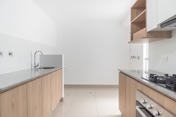 apartment kitchenette with upper and lower cabinets