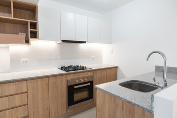 apartment kitchenette with upper and lower cabinets