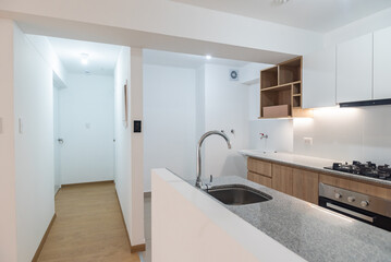 apartment kitchenette with upper and lower cabinets