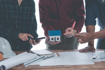 Engineers are helping design blueprints and working together on structural analysis. Architect Two engineers point to blueprints of architectural building drafting. Close-up pictures