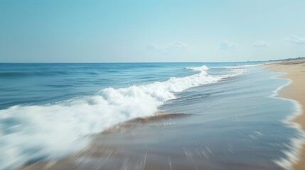 Fototapeta premium Waves roll onto a sandy beach