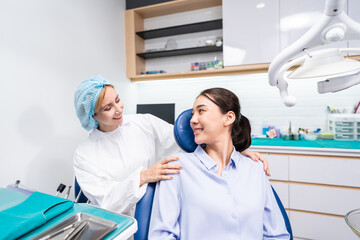 Fototapeta premium Caucasian dentist examine tooth for young girl at dental health clinic. 
