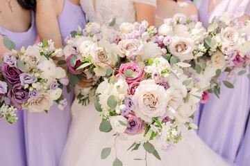 bride holding bouquet with wedding party