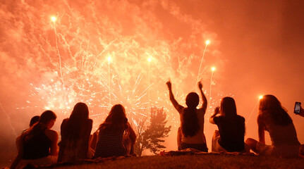 Girls watching fireworks, dancing to music