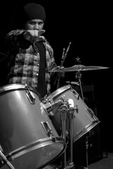 musician drummer points his hand at the camera, black and white photograph
