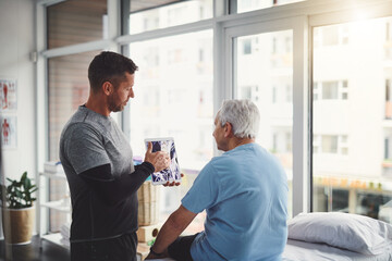 Elderly, man and tablet in physio with Xray consultation for joint injury, healing and treatment planning. Rehab, senior person and chiropractor with digital technology for patient muscle health