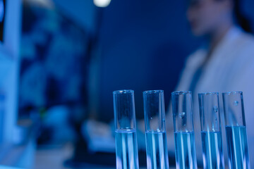 scientist is working on an important liquid inside tube in laboratory, the discovery of a vaccine to protect against currently spreading virus has been discovered, wear gloves and goggles for safety