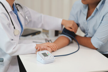 The doctor woman hand use the pulse meter to measure the pressure of the patient, medical checkup concept. - Powered by Adobe