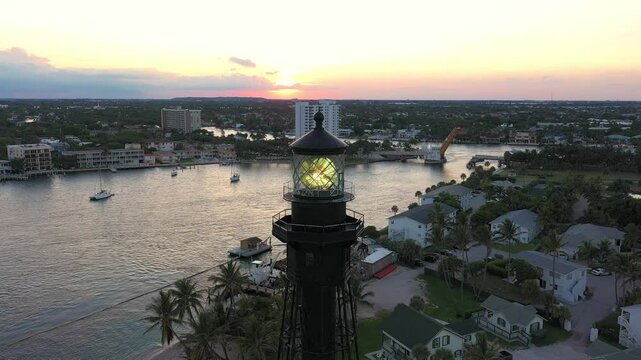 Hillsboro Lighthouse close aerial view at sunset with moving Fresnel lens. Pompano Beach, Florida established in 1907