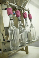 Automated Bottling Line Filling Four Bottles in Factory