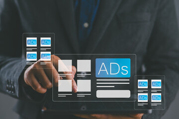 Programmatic advertising concept. Businessman use tablet with advertising on website, planning advertising marketing strategies to target social media native, ad, advertisers, sales, marketing digital
