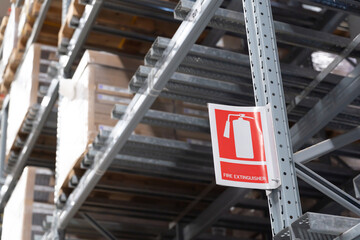 Fire extinguishers sign in the warehouse. Fire Safety at Cargo Storage.