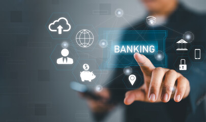 Naklejka premium Businessman holding word banking in hand with icon network connection on virtual screen dark background