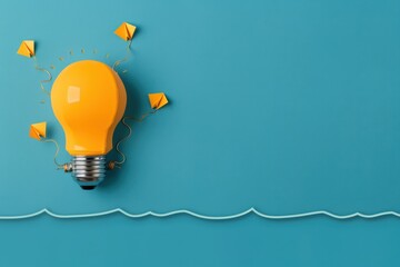A yellow lightbulb with small kites attached to it on a blue background, symbolizing creativity, innovation, and bright ideas.