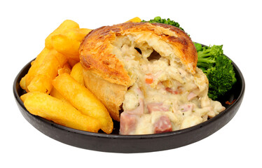 Creamy chicken, ham and leek pie meal with chips and mixed vegetables isolated on a white background