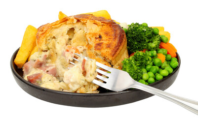 Creamy chicken, ham and leek pie meal with chips and mixed vegetables isolated on a white background