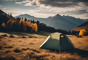 A tent set up in a scenic autumn forest with colorful foliage and mountains in the background.