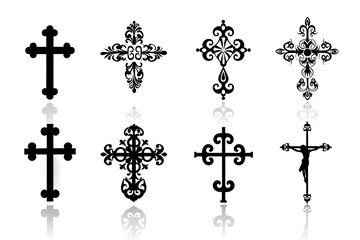 A collection of ornate decorative crosses with intricate designs in black silhouette.