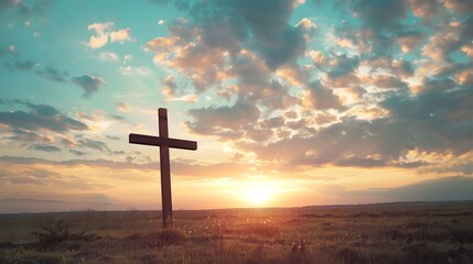 A solitary wooden cross stands tall against a serene sunset, symbolizing faith and peace.