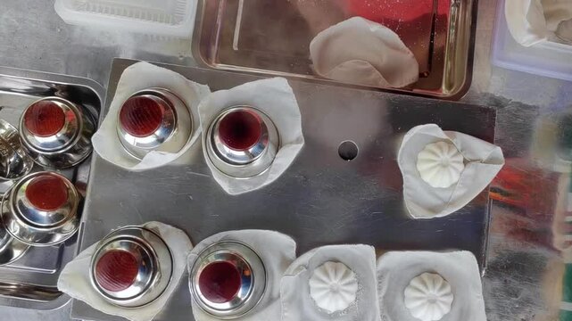 Top down view of making Putu Perak by placing the mould on a white cloth. Snacks in Malaysia. 4K Vertical