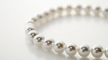 Obraz premium Close up of a pearl necklace on white background with space for text